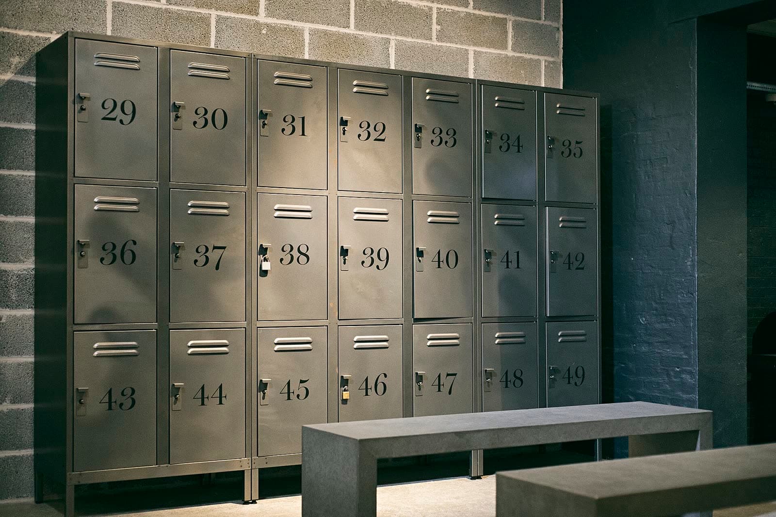 Locker room with numbered lockers and bench seating